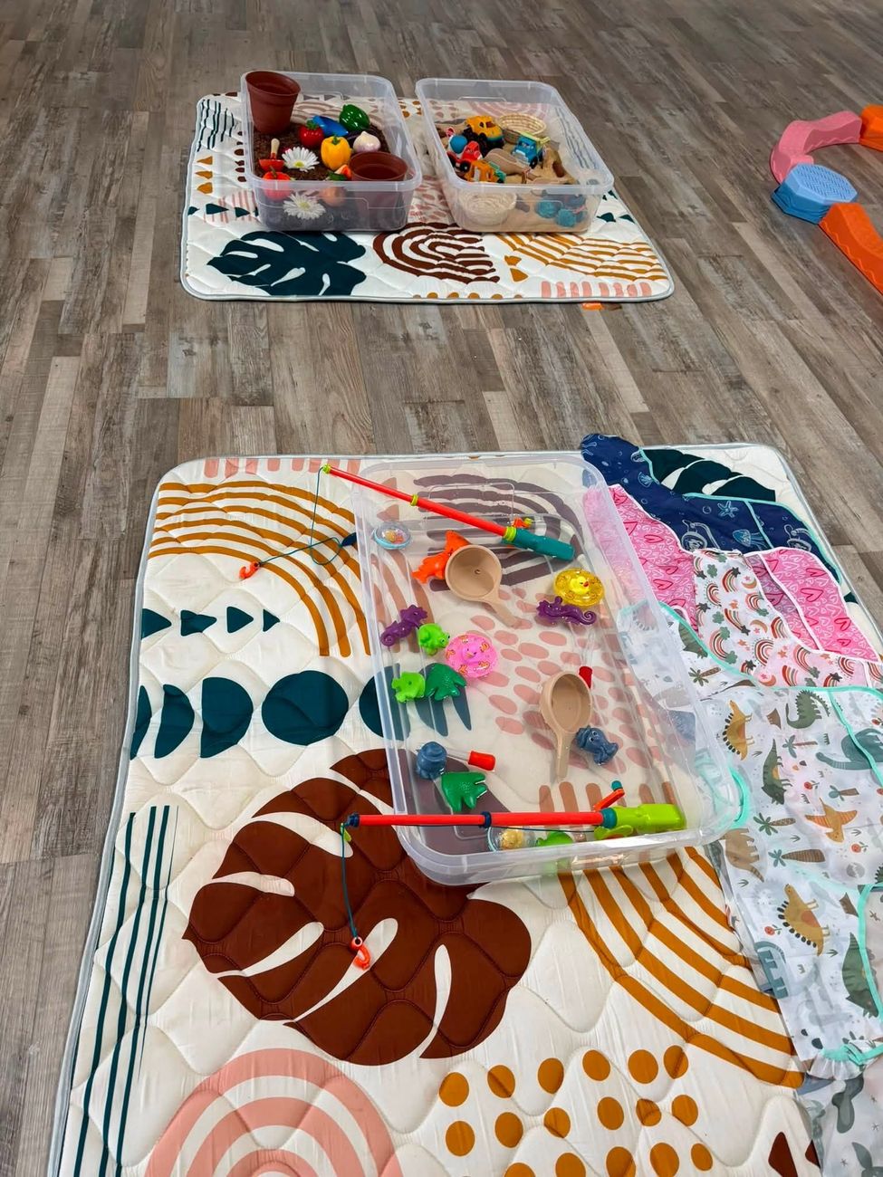 Themed sensory bins ready before class, with water play, scoops and smocks